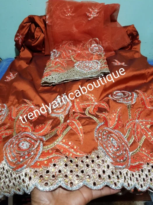 Nigerian Tranditional George wrapper. Embriodery/stones design in Burnt Orange and a matching net for blouse. Small-George. Superior quality African embroidery George. Feel the differencein quality. Satin Long Blouse Nigerian Tranditional George wrapper. Embriodery/stones design in Burnt Orange and a matching net for blouse. Small-George. Superior quality African embroidery George. Feel the differencein quality. Satin Long Blouse